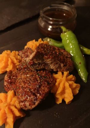 A picture of Lamb steak dive in chocolate sauce.