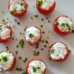 A picture of Pomordorini e caprino cherry tomatoes stuffed with goat's cheese.