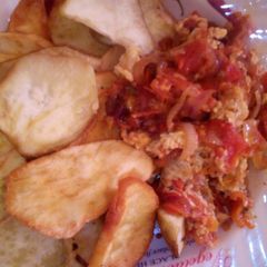 A picture of Fried potatoes and egg sauce.