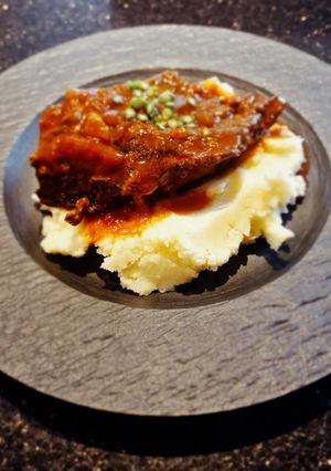 A picture of Slow Braised Beef Cheek in Guinness with Champ.