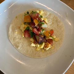 A picture of Vegetarian breakfast tacos with pico de gallo.