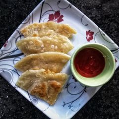 A picture of Aloo ke parathe with tomato chutney.