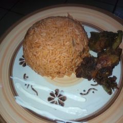 A picture of Jollof Rice and Chicken.