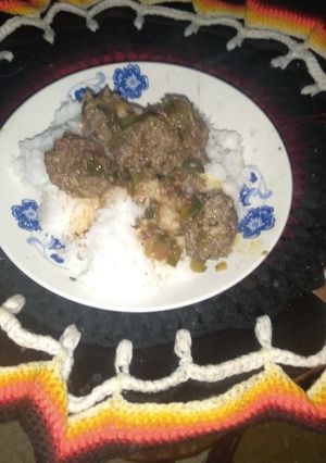 A picture of Rice and stewed meatballs.