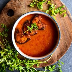 A picture of Rohu Fish in tomato-mustard curry.