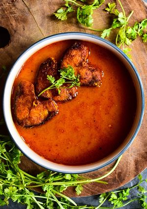 A picture of Rohu Fish in tomato-mustard curry.