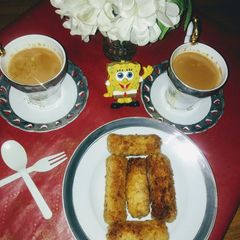 Bread crumbs chicken rolls with elaichi tea A picture of Bread crumbs chicken rolls with elaichi tea.