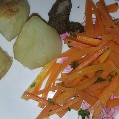 A picture of Roast potatoes with buttered carrots.