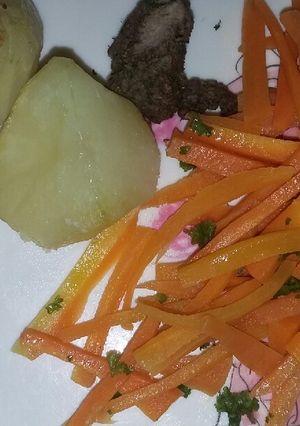 A picture of Roast potatoes with buttered carrots.
