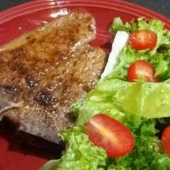 T-Bone Steak with Lettuce and Baby Tomato Salad A picture of T-Bone Steak with Lettuce and Baby Tomato Salad.