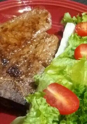 A picture of T-Bone Steak with Lettuce and Baby Tomato Salad.