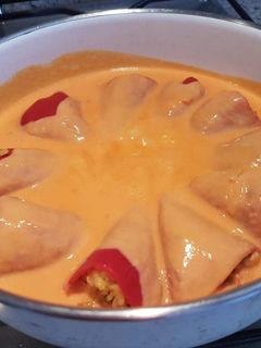 Una foto de Pimientos del piquillo rellenos de paella y con una rica salsa