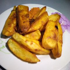 A picture of Fried potato with chilli pepper and oil.