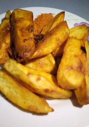 A picture of Fried potato with chilli pepper and oil.