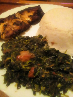 A picture of Pan fried fish served with ugali, managu and terere.
