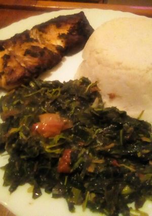 A picture of Pan fried fish served with ugali, managu and terere.