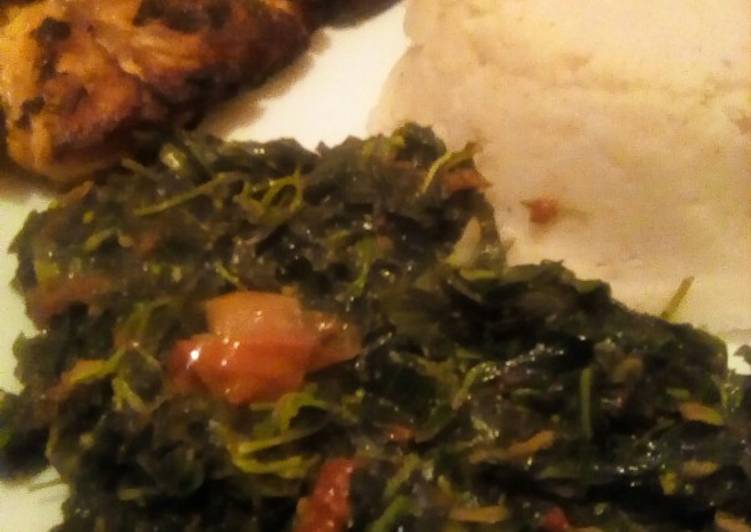 Pan fried fish served with ugali, managu and terere