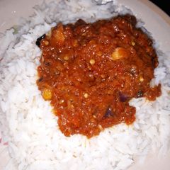 A picture of White rice and red oil stew.
