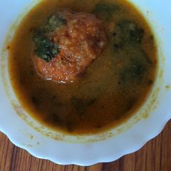 A picture of Egg curry with spinach.