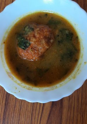 A picture of Egg curry with spinach.