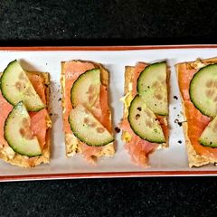 A picture of My pineapple + Almond Roulè with Smoked Salmon on cracker #Snack.