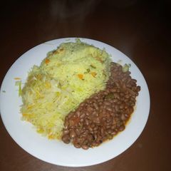 A picture of Tumeric rice, beans and steamed cabbage.