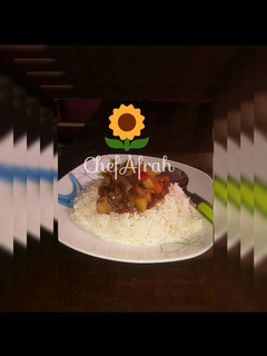 A picture of White rice and potatoes sauce.