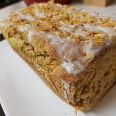 A picture of Carrot & Banana Cake topped with icing and Banana crisp. 😀.