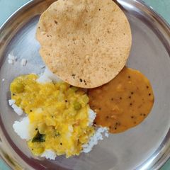 A picture of Rice with Molaghootal, Dry Neem flower Pachdi & papad.