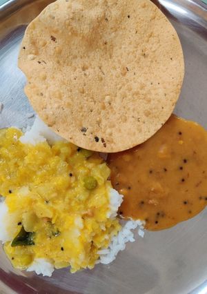 A picture of Rice with Molaghootal, Dry Neem flower Pachdi & papad.