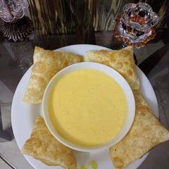 A picture of Chilled Mango Shake with homemade poriyan.