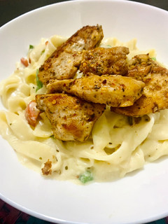 A picture of Grilled chicken with Fettuccine Alfredo.