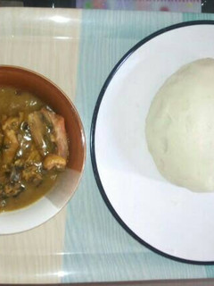 A picture of White soup and pounded yam.