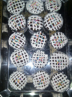 A picture of Chocolate cupcakes with whipped cream frosting.