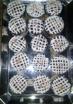 A picture of Chocolate cupcakes with whipped cream frosting.