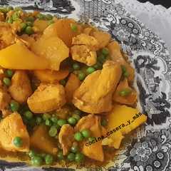 Una foto de Pollo en amarillo con almendras y guisantes