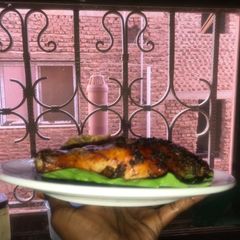 Jollof rice with grilled chicken A picture of Jollof rice with grilled chicken.