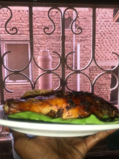 A picture of Jollof rice with grilled chicken.