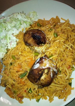 A picture of JOLLOF Rice with fish and coslow.