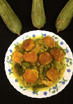 A picture of Dal Fritters in Ridge Gourd curry.