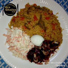 A picture of Jallof rice with coleslow.
