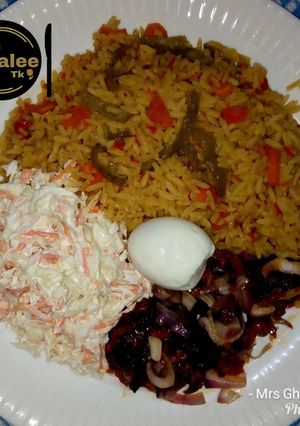 A picture of Jallof rice with coleslow.