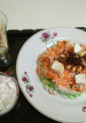 A picture of Tri colour veg pulav with veg raita and masala papad.