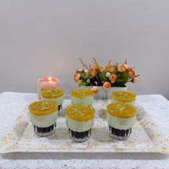 A picture of Fruit custard blackcurrant jelly with mango sauce.