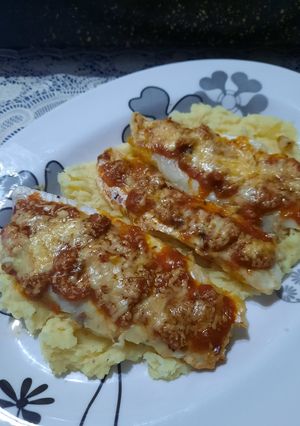 Una foto de Merluza a la pizza