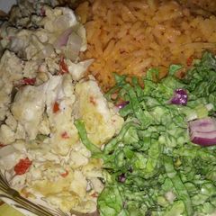 A picture of Jollop rice and salad with scramble egg.