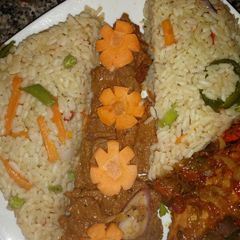 A picture of Cinnamon rice with suya and peppered grilled chicken.