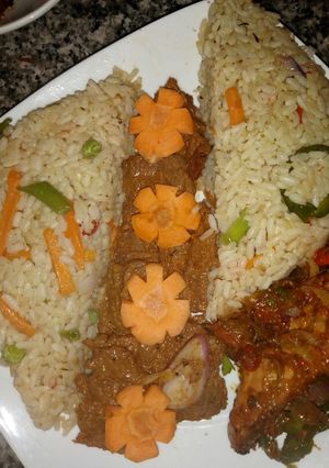 A picture of Cinnamon rice with suya and peppered grilled chicken.