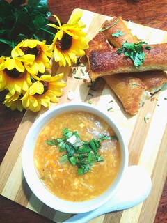 A picture of Hot and Sour Soup with Crispy Cheese Bread Rolls.