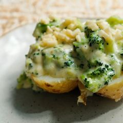 A picture of Baked potato with classic broccoli cheddar sauce.